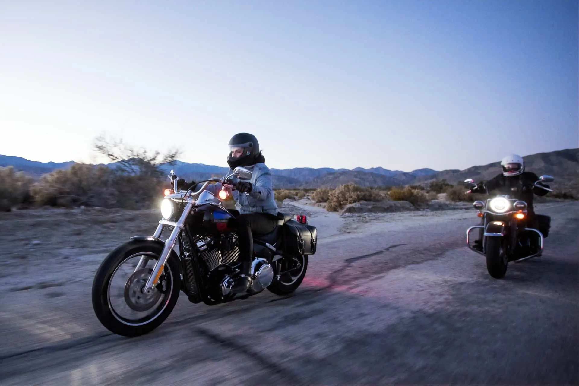 two people riding motorcycles